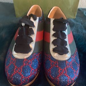 Gucci Sneakers “GG" monogram sections, silver trim detail a black ribbon laces